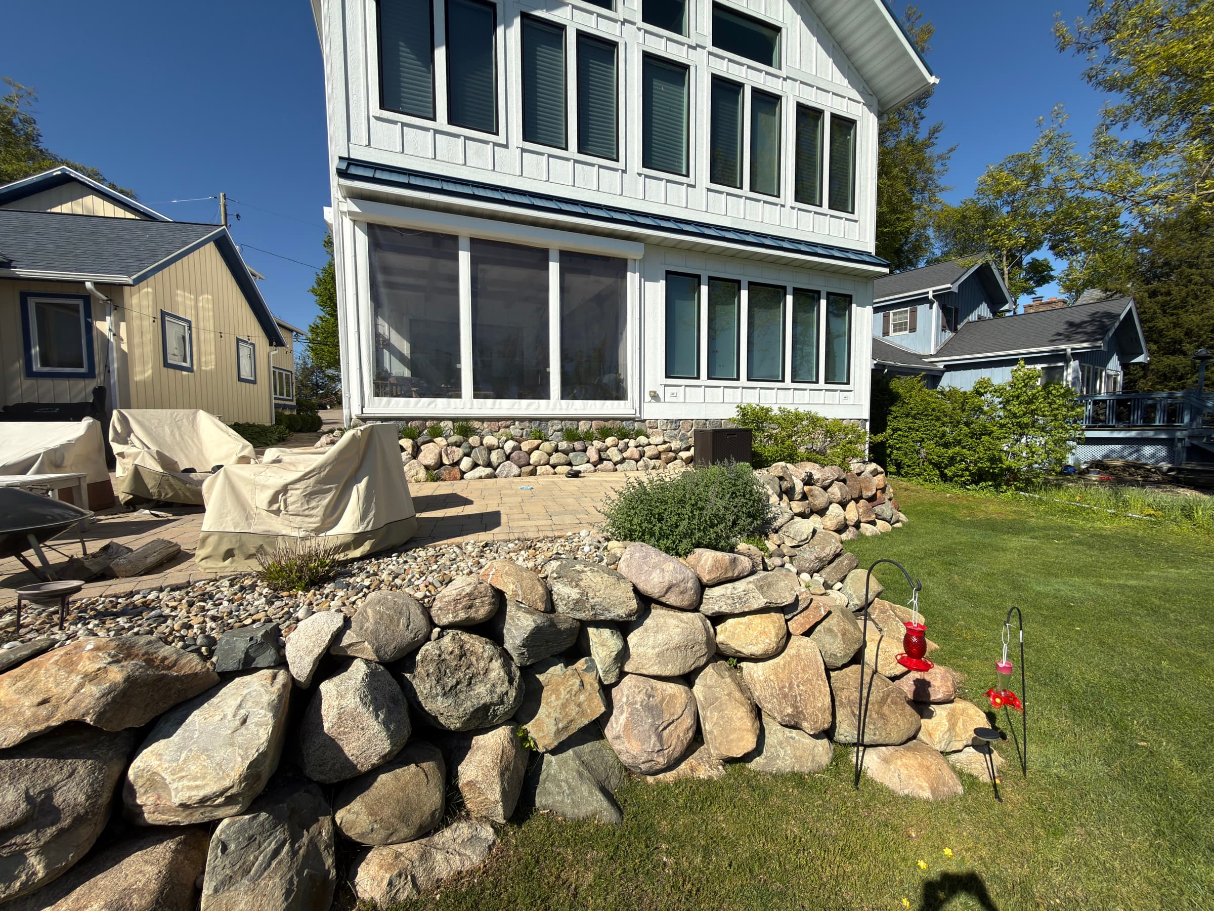 Natural boulder retaining wall alongside a Southwest Michigan lake house