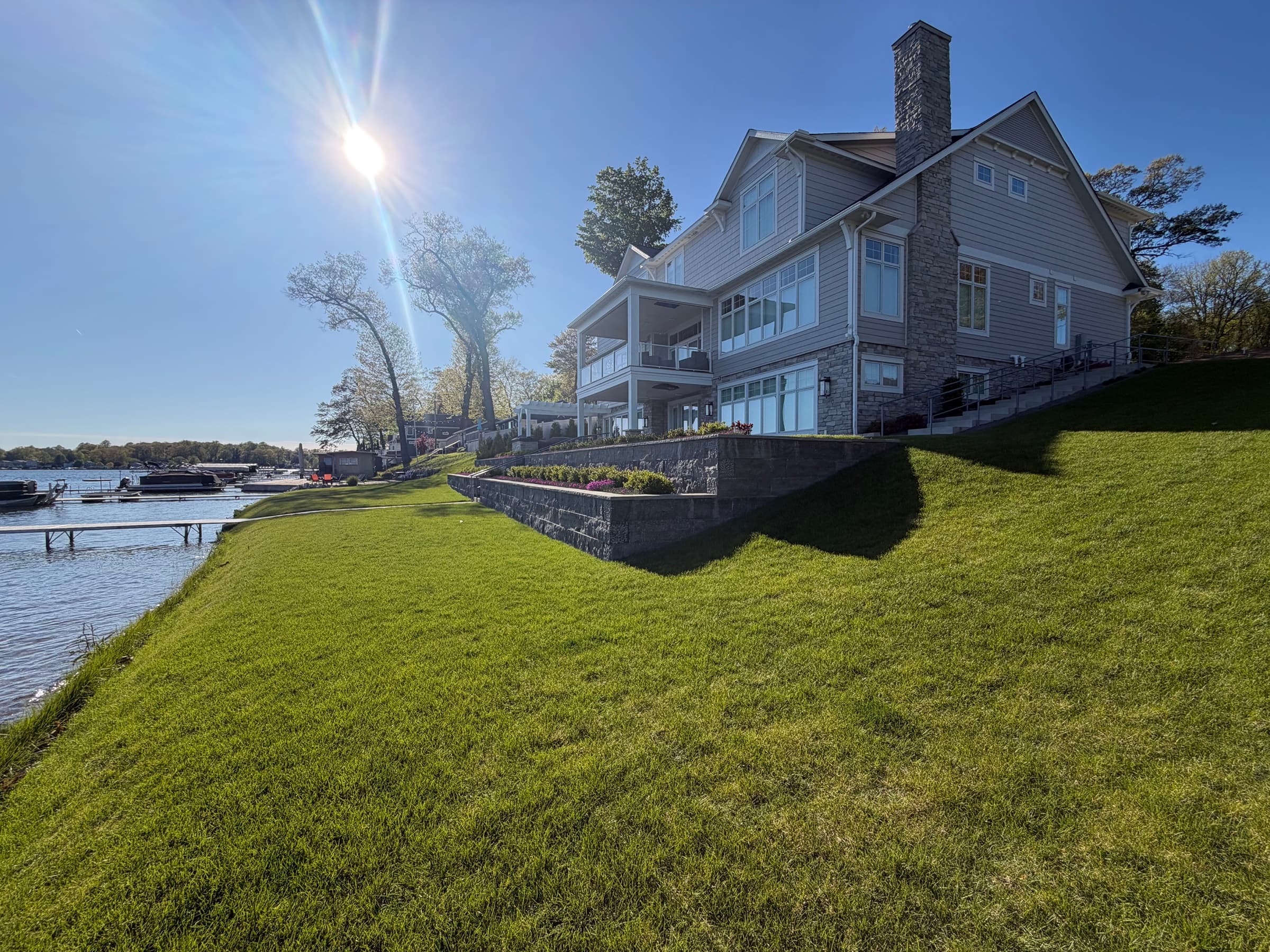 Lakefront estate with manicured lawn and tiered stone terrace, Southwest Michigan