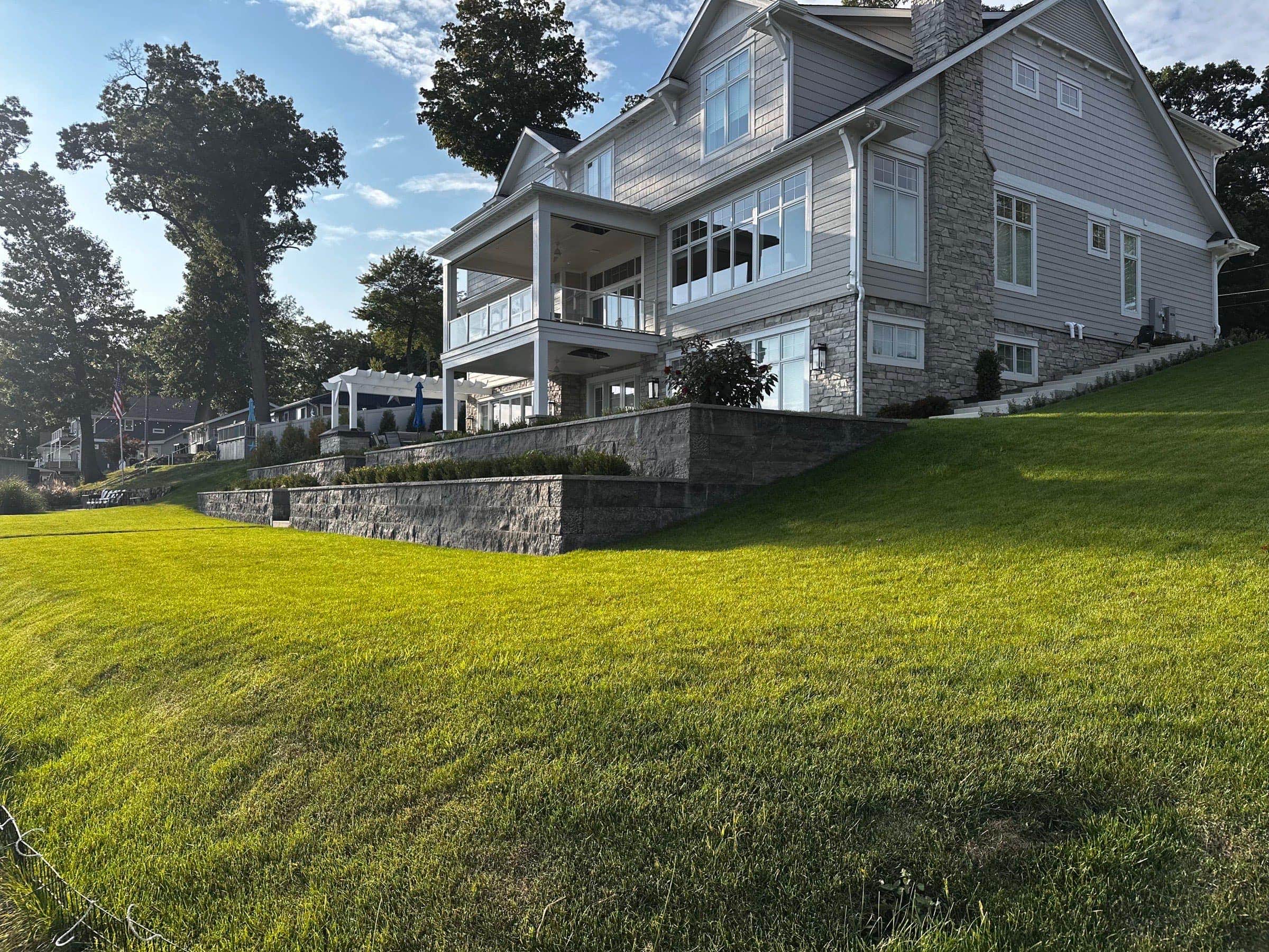 Large terraced hillside retaining wall with lake view — large-scale landscaping project